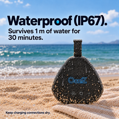 Black OontZ Angle Solo Gen 5 on a beach, with visible water droplets and sand on its exterior. IP67 dust and water resistance; keep charging connections dry. AI lifestyle illustration.